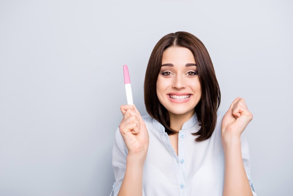 Young brunette holding a pregnancy test