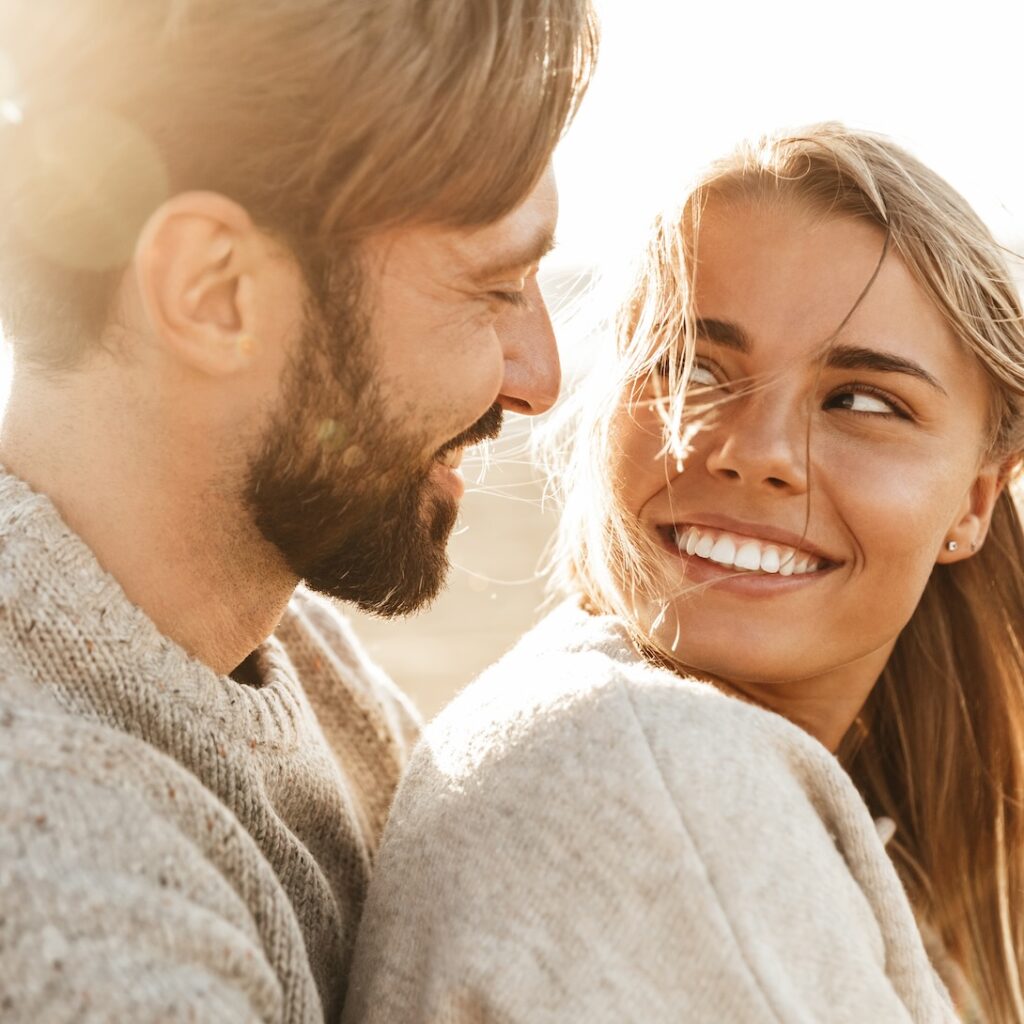 Happy couple looking at each other with admiration, exemplifying the joys and considerations of family planning.
